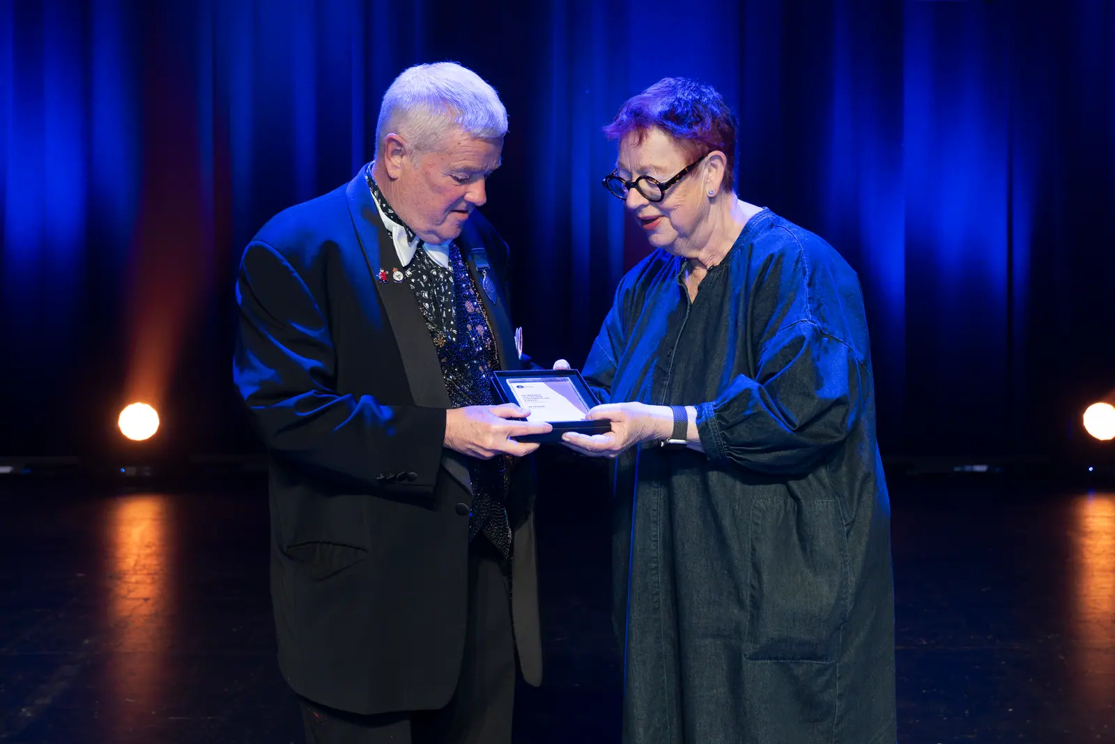 Les Heyhoe receiving the Incredible Volunteer Contribution Award from Jo Brand.