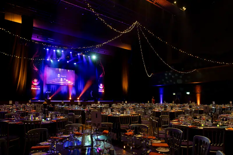 The ballroom at G Live, tables laid and the stage lit, ready for the ceremony.