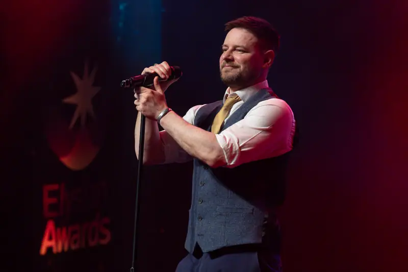 A singer at the microphone stand during the live music.