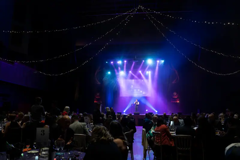 The room watching the stage as the live music begins.
