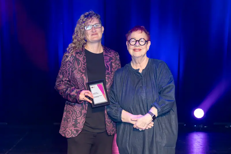 A winner standing with Jo Brand after receiving her award.
